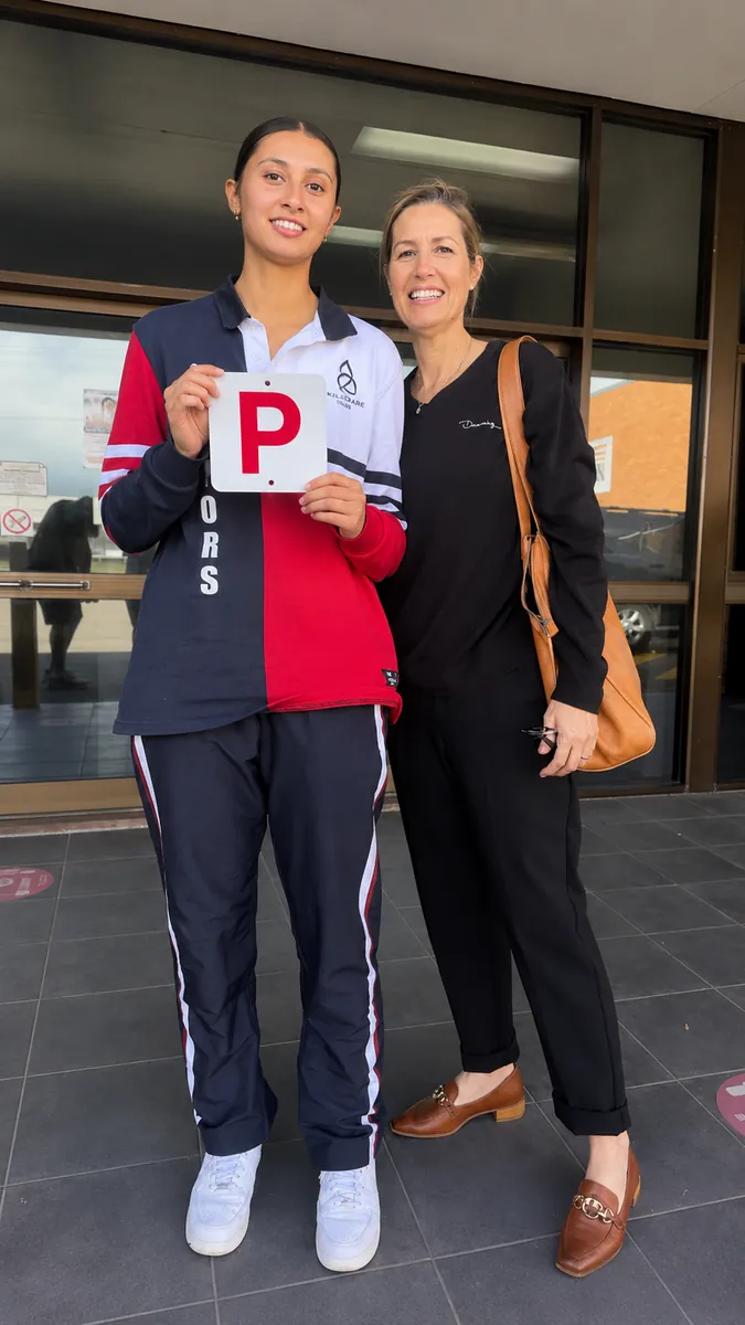 Kobee celebrating her pass with her mum