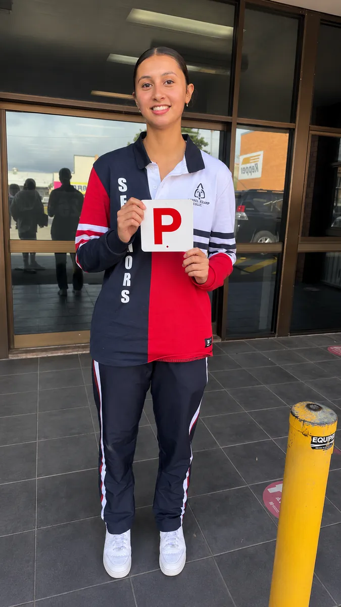Kobee smiling with her P plates after passing first go at Wynnum